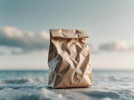 A paper bag sitting on the beach with the ocean in the background photo