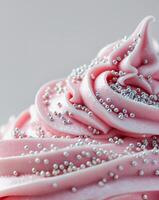 A close up of a frosted cupcake with sprinkles photo