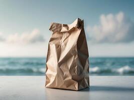 A brown paper bag sitting on a table in front of the ocean photo