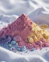 a close up of a pile of colored powder on a white surface photo