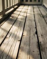 A wooden deck with sunlight shining through the windows photo