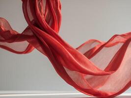 A red silk scarf is flying in the air photo