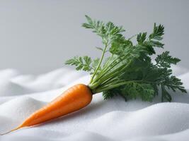 A carrot is sitting on top of a white surface photo
