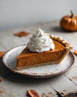 Pumpkin pie with whipped cream on a plate photo