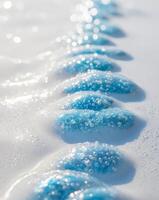 A row of blue bubbles on a white surface photo