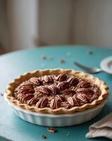 Delicious Pecan Pie in White Dish on Teal Table photo