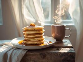 Stack of pancakes with syrup and coffee on a wooden table photo