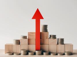 A red arrow pointing up from stacks of coins photo