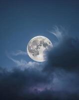 the night sky with a beautiful full moon that is cloudy and bright photo