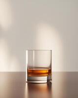 there is a glass of whiskey sitting on a table photo