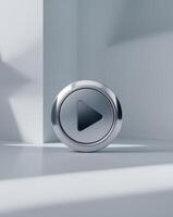 metallic play button showing beginning on gray background photo