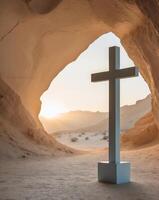 A cross stands in front of a cave with the sun shining through photo