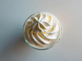 A white frosted drink with whipped cream on top photo