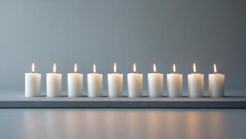 A row of white candles on a table photo