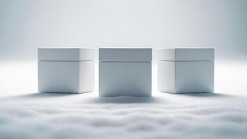 Three white boxes sitting on top of snow photo