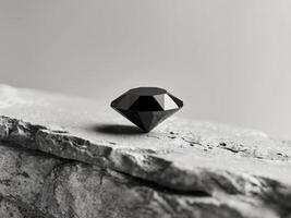 A black diamond is sitting on a rock photo