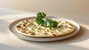 Delicious garlic naan bread garnished with fresh herbs on plate photo