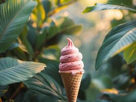 An ice cream cone with pink frosting sitting in front of some leaves photo