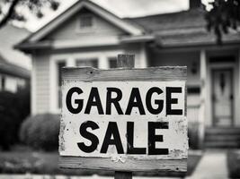 Garage sale sign in front of house photo