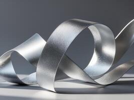 Abstract metallic ribbon in silver tones on a sleek gray background photo