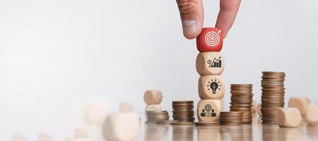 Business strategy concepts and action plans are planned by targeting marketing, goals, success and business development. Hand holding wooden blocks with arrangement icons photo