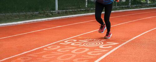 New year 2025 concept, beginning of success. Text 2025 written on asphalt road and male runner preparing for the new year. Concept of challenge or career path and change. photo