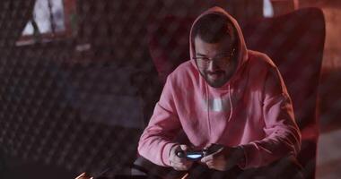 Millennial guy playing videogame in cafe video