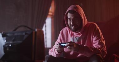 Man resting in lounge bar with videogame video