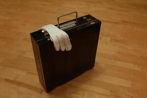 Black suitcase still life Black suitcase, white gloves still life, tricks inside, Circus photo