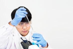 Portrait asian man student scientist or doctor look hand holding reagent mixing laboratory in science research laboratory with test tubes of various size in laboratory chemistry lab white background photo
