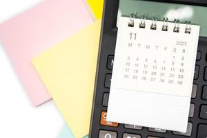 Simple desk calendar for NOVEMBER 2025 on calculator. Calendar concept with copy space. 2025 NOV calendar. photo