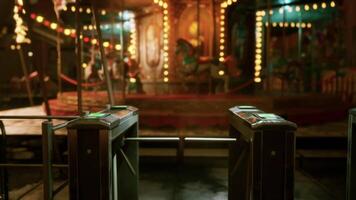 Empty amusement park at night with glowing lights and still attractions video