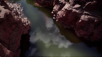 Peaceful reflection on the Colorado River surrounded by rocky canyon walls video