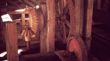 Detailed view of vintage gears in a timber structure during daylight video