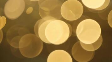 Abstract golden bokeh background with blurred circles of light. video