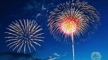 A single firework bursts in the night sky, creating a colorful display of pink and yellow light. video