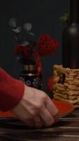 Vertical . Person setting table for St. Valentines Day celebration. Preparing for romantic date or candlelight dinner. video
