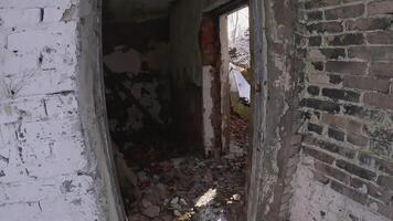 An eerie and haunting view of a doorway that leads into an abandoned structure that is surrounded by snow video