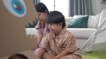 A child and his mom having fun and relaxing on a holiday together in the living room of the house video