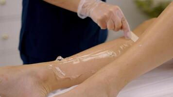 Close Up of Leg Waxing Procedure in Spa Setting video