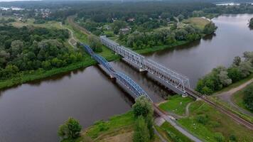 Parallel Railway Bridges Crossing River in Rural Landscape video