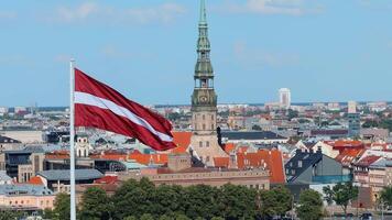 Skyline of Riga with St. Peter's Church and Latvian Flag video