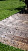 Weathered Wooden Deck with Tree Shadow in Garden Setting video