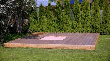 Wooden Platform with Sandbox in a Private Garden Setting video