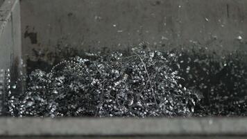 Coiled Metallic Shavings in Industrial Container with Gray Background video