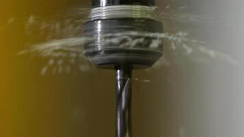 Close Up of Metal Drill Bit with Flowing Liquid in Dim Lighting video