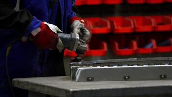 Worker in Protective Gear Grinding Metal Component in Workshop video