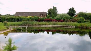 Reflective Pond with Rustic Building and Wooden Dock video