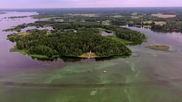 Aerial View of Forested Island with Structure and Boats on Water video