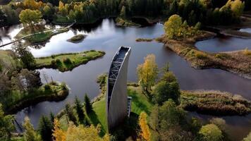 Modern Angular Watch Tower Amidst Autumnal Water Bodies and Islands video